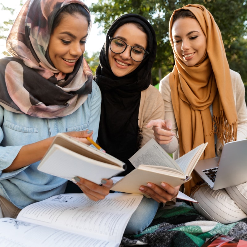 Female students are looking at the book